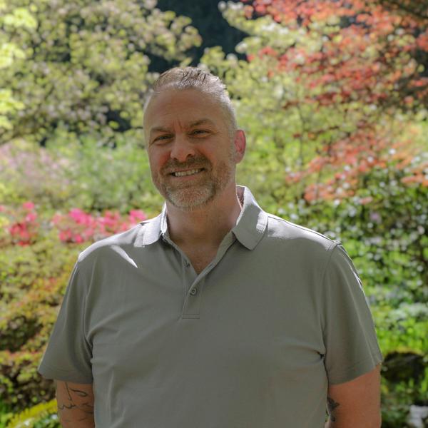 Man standing in garden posing for a staff photo