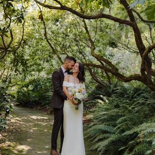 Couple taking wedding photos in a rhododendron garden